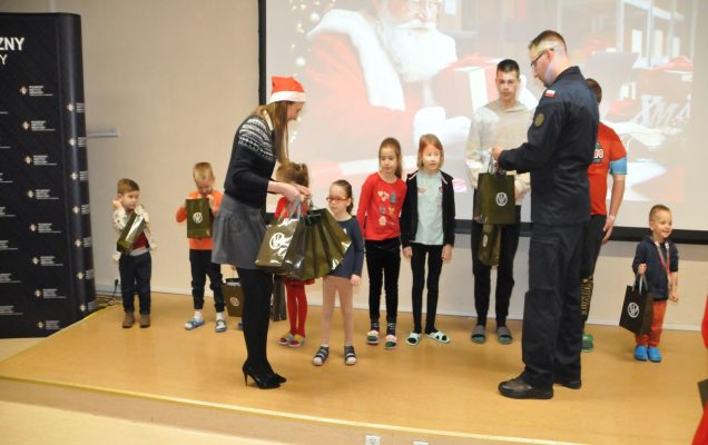 Mikołajki - Wojsko Polskie dzieciom - dzieci dostają prezenty, w tle święty mikołaj