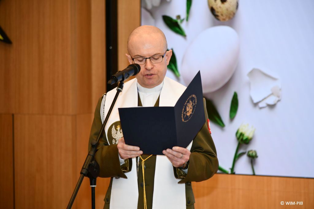 Ksiądz czyta życzenia wielkanocne.
