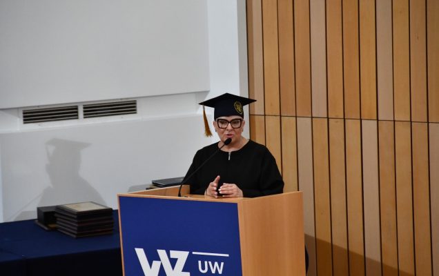Lidia Wojda w todze przy mównicy.