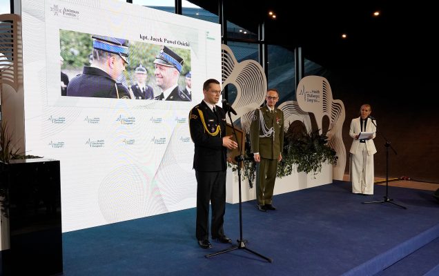 Paweł Osicki na scenie przy mikrofonie ze statuetką Animus Fortis.